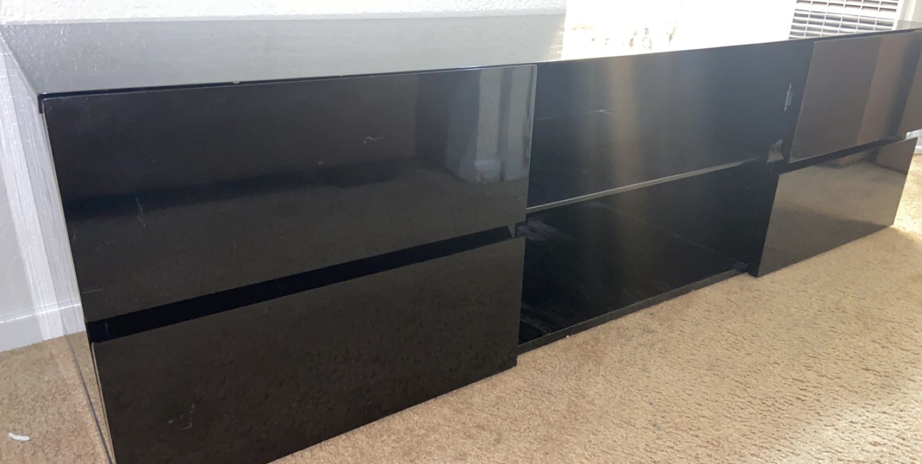 Black modern T.V stand with shelving and storage space. ‘55 wide.