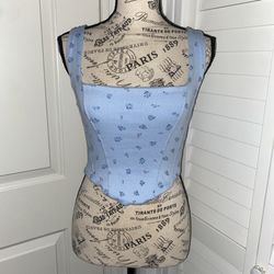 blue corset top with a cute floral pattern and tying on the back