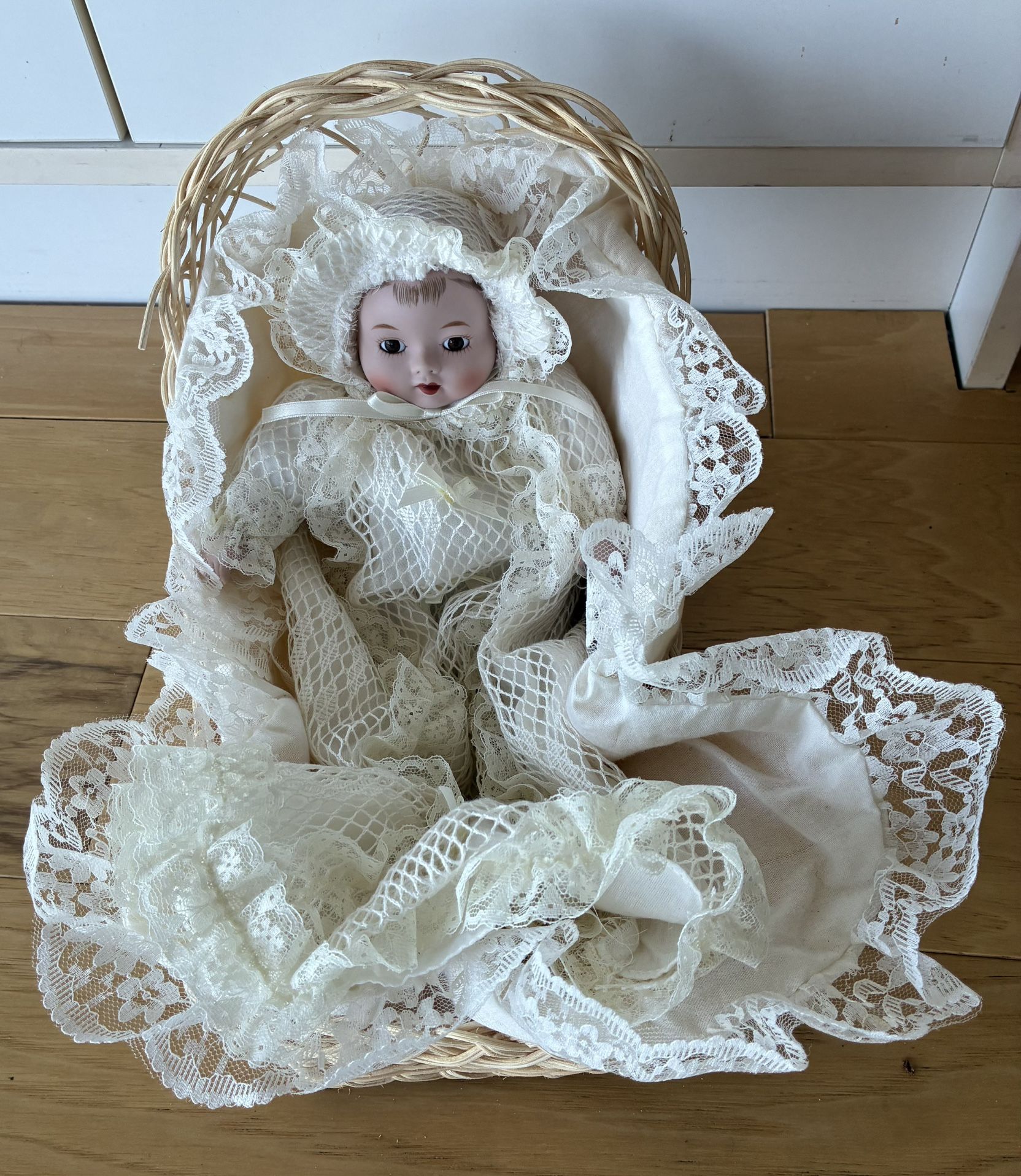Porcelain Doll in Beige Basket, 14” Tall, White Lace Long Dress and Bonnet.