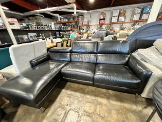 Black leather sofa with chaise and headrests