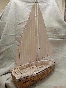 Sailboat featuring a metal rustic-looking sail Thumbnail