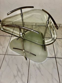 Vintage 1980's two-tiered glass and metal roll-away table