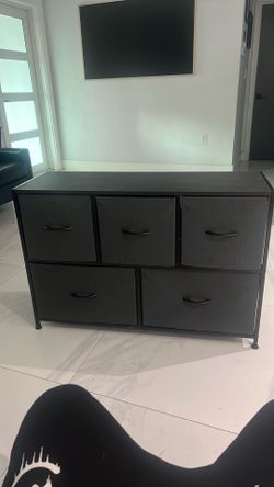 5-drawer fabric dresser with a black metal frame and a wood-look top.