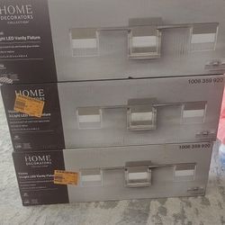 Home Decorators Collection 
VICINO 21.26 in. W x 5.71 in. H 3-Light Brushed Nickel Integrated LED Bathroom Vanity Light with Rectangular Shade