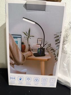 LED desk lamp with adjustable cool/warm light and wireless phone charging.