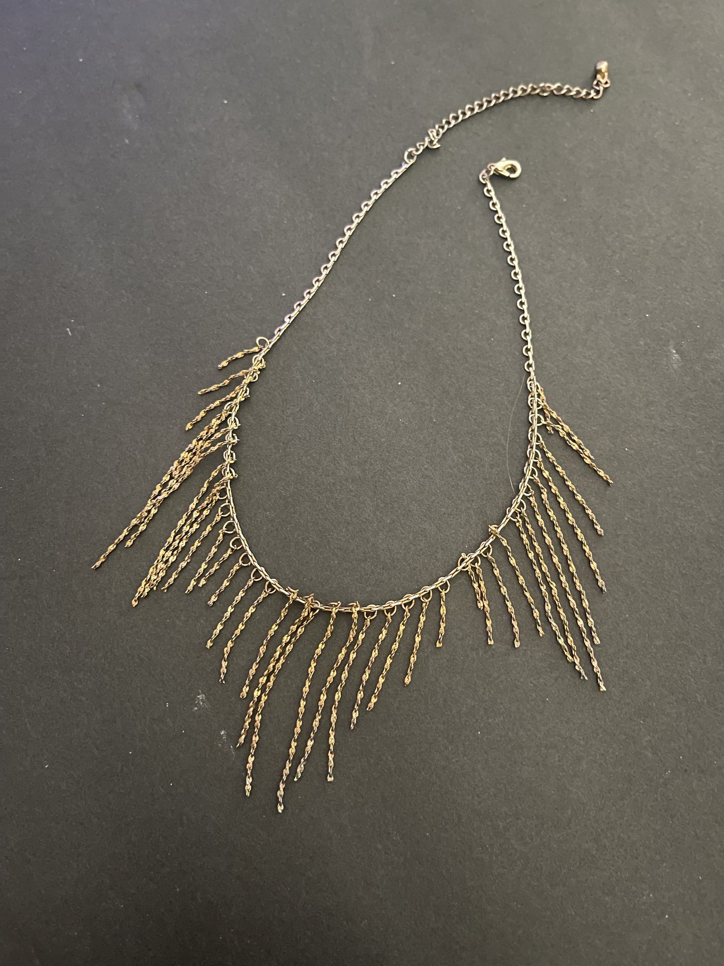 Gold tone fringe necklace