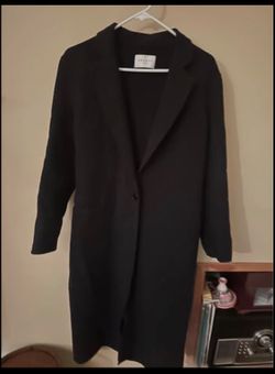 This Sandro black Dilan coat is designed in a minimalist style with a single-button closure