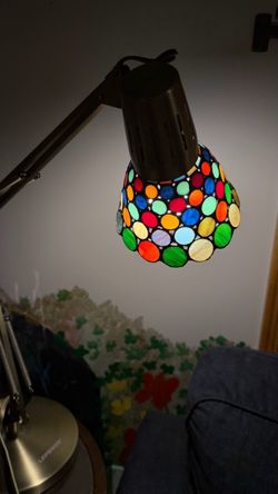 A colorful, multi-dot stained glass Tiffany-style rotating table lamp 30” tall