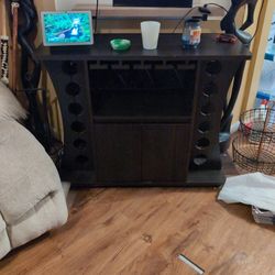 With Wine Racks On The Side And Glasses In The Middle