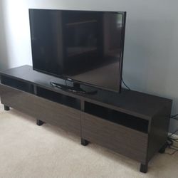 Dark brown TV unit with push-open drawers