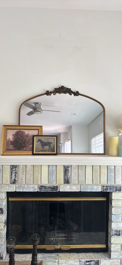 Sturdy wooden console table with a dark brown finish. This piece has three tiers of shelving and decorative scrollwork cutouts on the side panels. The