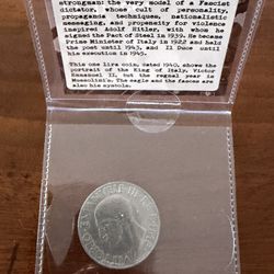vintage Italian 1 Lira coin from 1940, featured within a protective holder labeled "Il Duce: Italy at War”