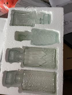 set of four clear glass liquor or whiskey decanters with matching stoppers,