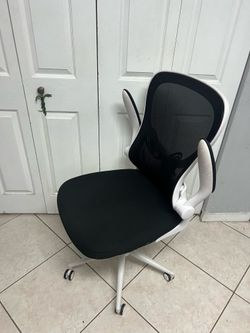ergonomic office chair featuring a white frame and black mesh,