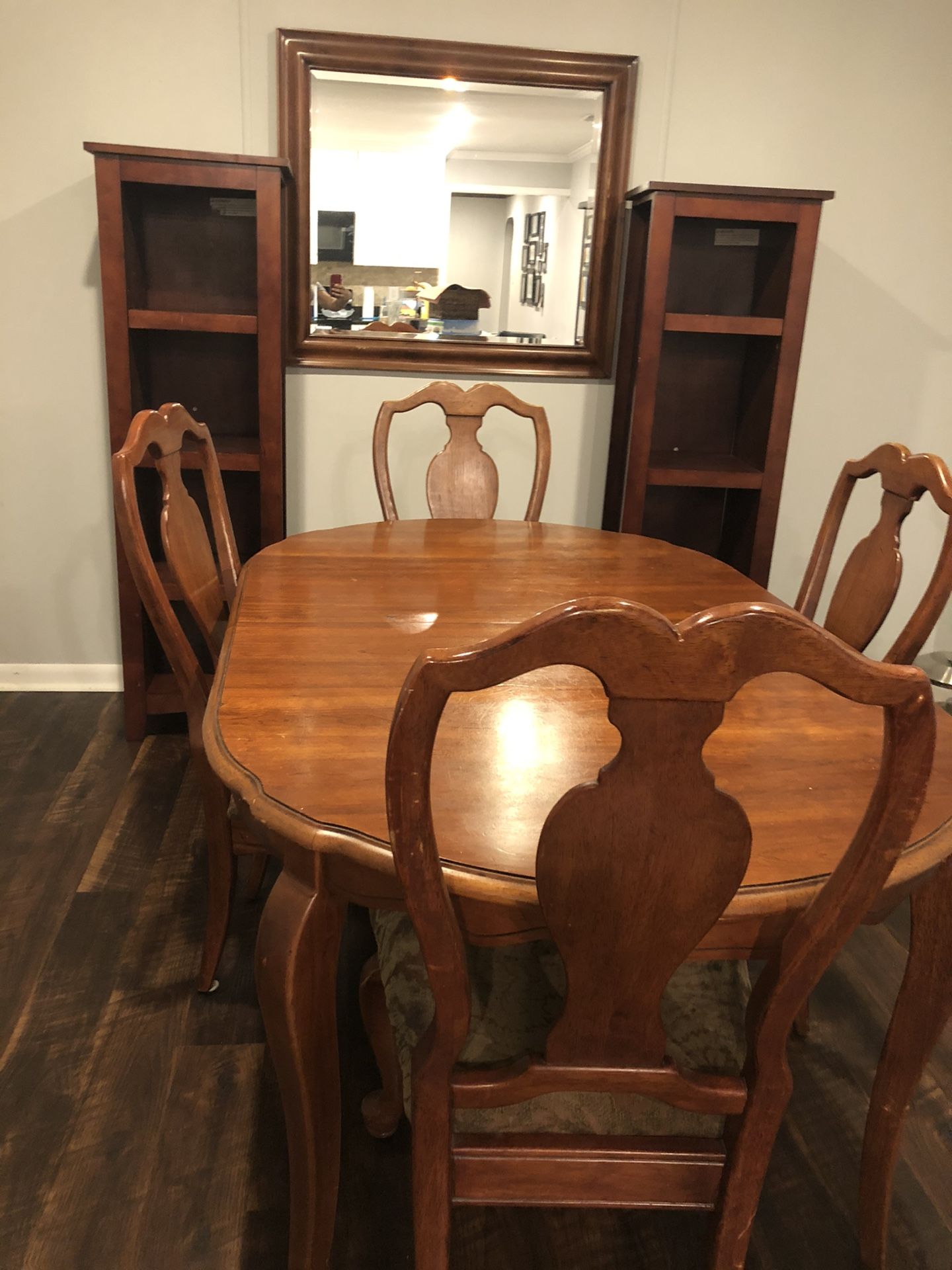 Wood table and 4 chairs. Used in good condition .bookshelves and mirror not included.