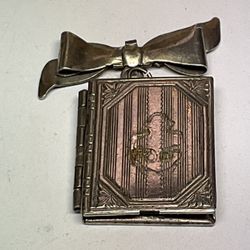 For sale is a Vintage Sterling Silver Opening Book Picture Locket Ribbon Charm.