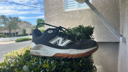 Black and white new balance turf shoes