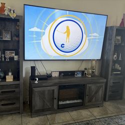 Tv stand with 2 lighted towers and fireplace