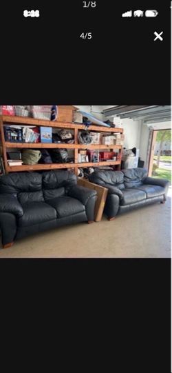 Navy blue leather couch and loveseat