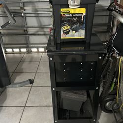 Two portable tool box one is medium size , one hand held and a push wheel tool box with drawers and a storage area in the bottom