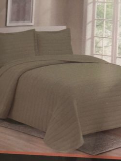 A bedspread set with 2 shams that are 20 in by 36 in