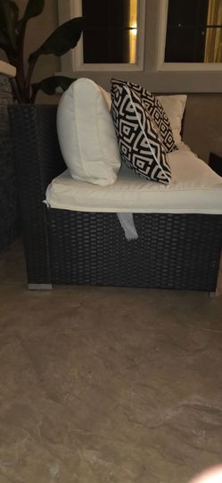 Black wicker patio set with glass table