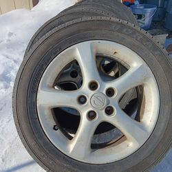 Four Nissan 5 Lug Tires and Rims 