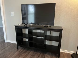 Black wood TV stand with shelves