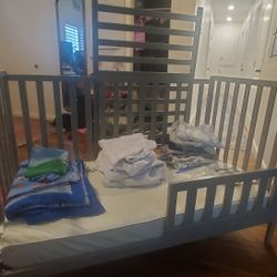 Delta Children 4-in-1 Convertible Crib with Mattress, Matress Protectors,  and Bedding