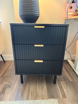 Black nightstand with gold handles