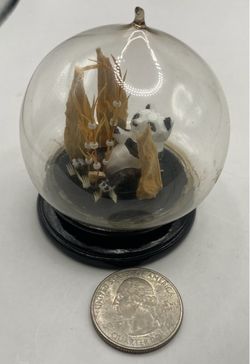 A vintage Chinese cork-carved panda diorama enclosed in a round glass dome with a black lacquer wooden base.