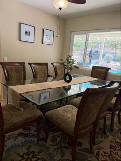 Large Glass Dining Table and Wooden Chairs Seats 8 by The Bombay Company