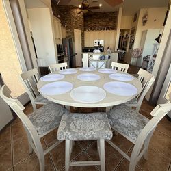 Convertible 60” counter height table with 8 chairs and built in lazy Susan