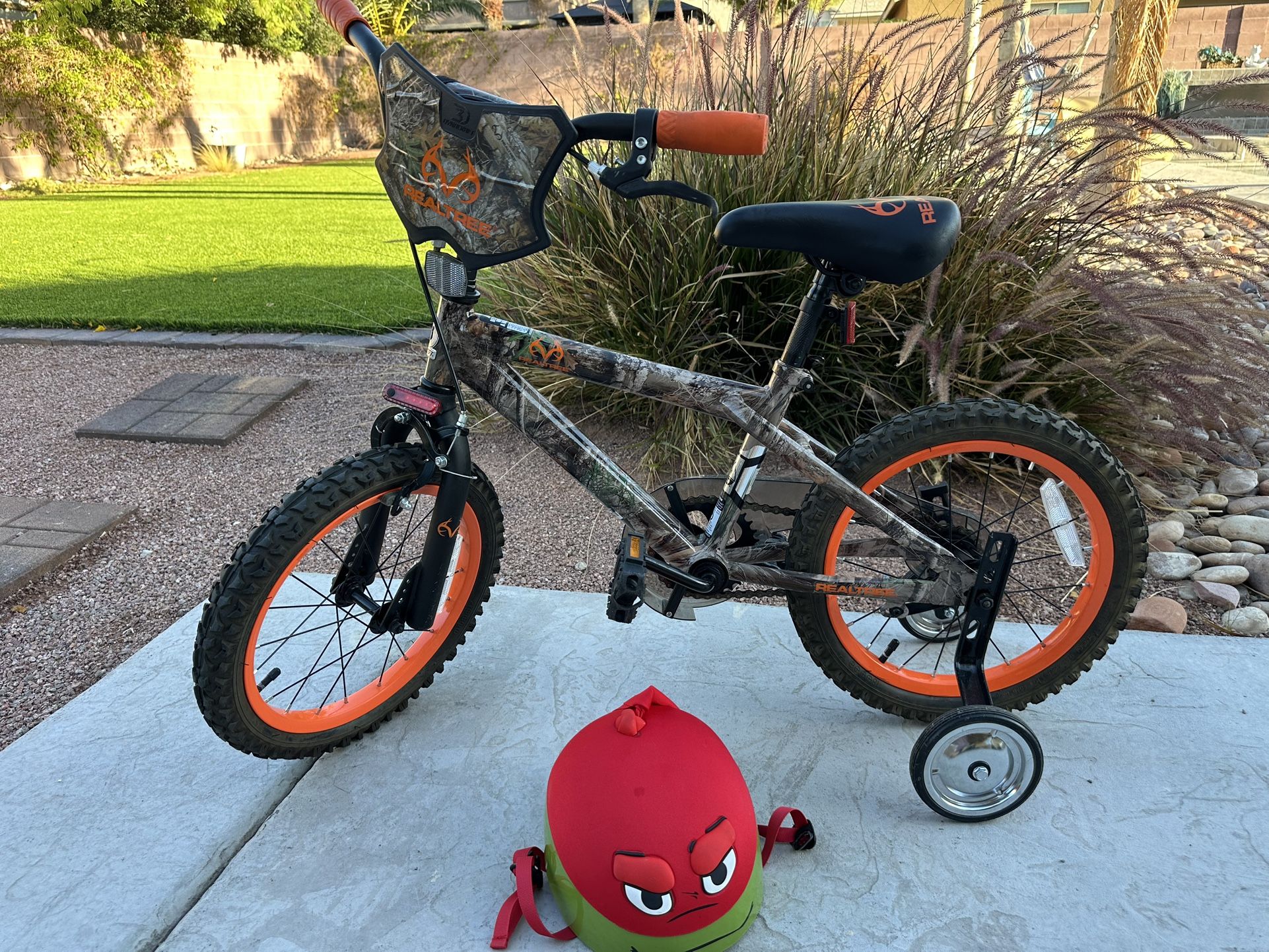 Realtree 16” BMX bike with training wheels and Teenage Mutant Ninja Turtles helmet