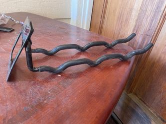 Black metal wall mount storage hock ideal for bikes