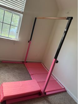 Gymnastics bar with foldable mats.