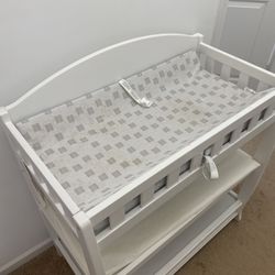 White diaper changing table with diaper changing pads