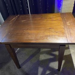 Wooden table with extenders on each side