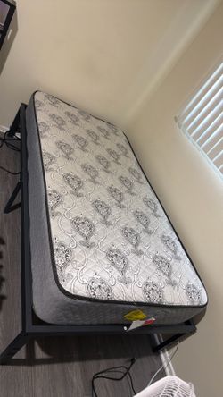 Twin mattress with the bed