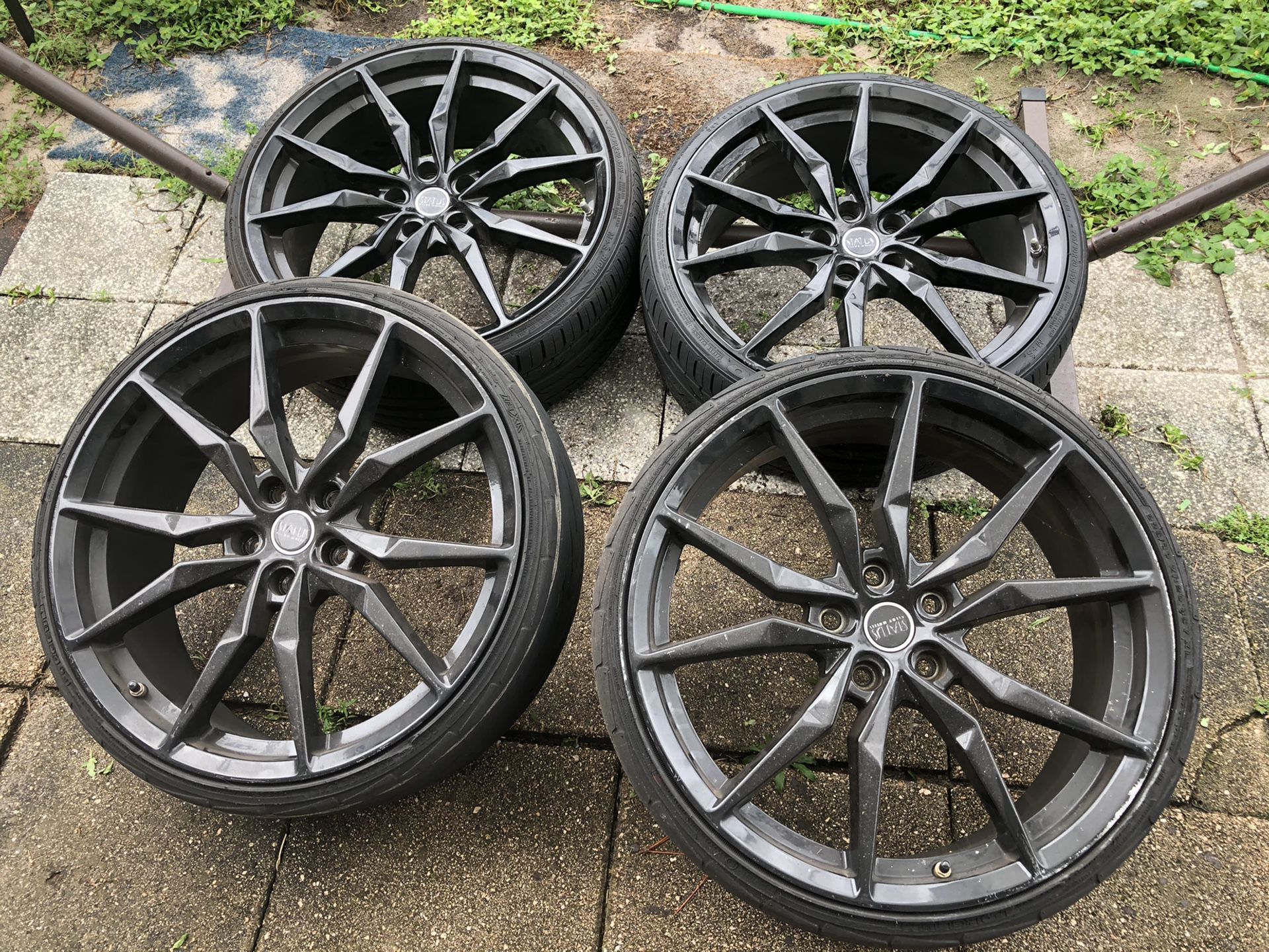 4 polished black wheels and tires