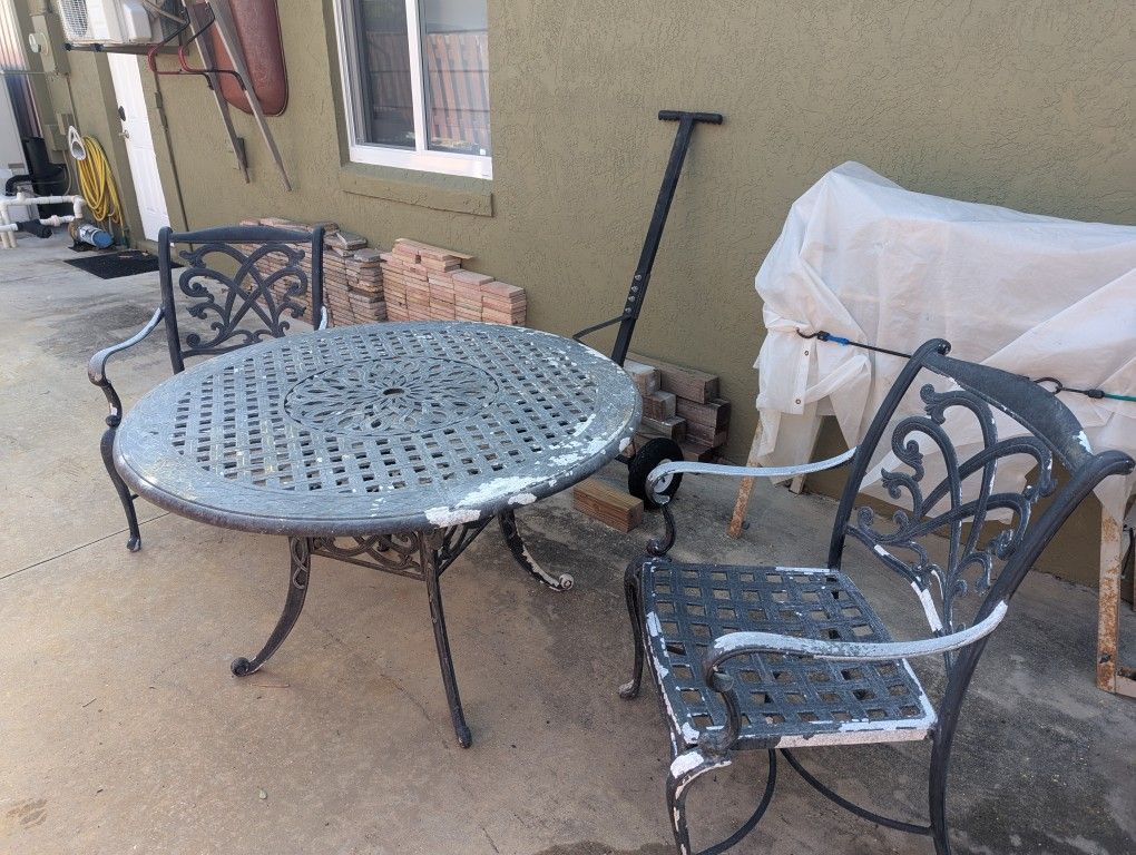 Solid Cast 48" Diameter Table And Two Chairs