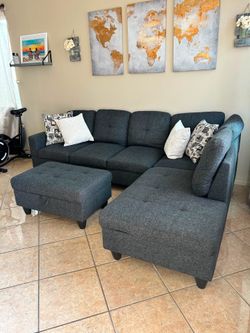 Beautiful charcoal grey sectional couch with storage ottoman