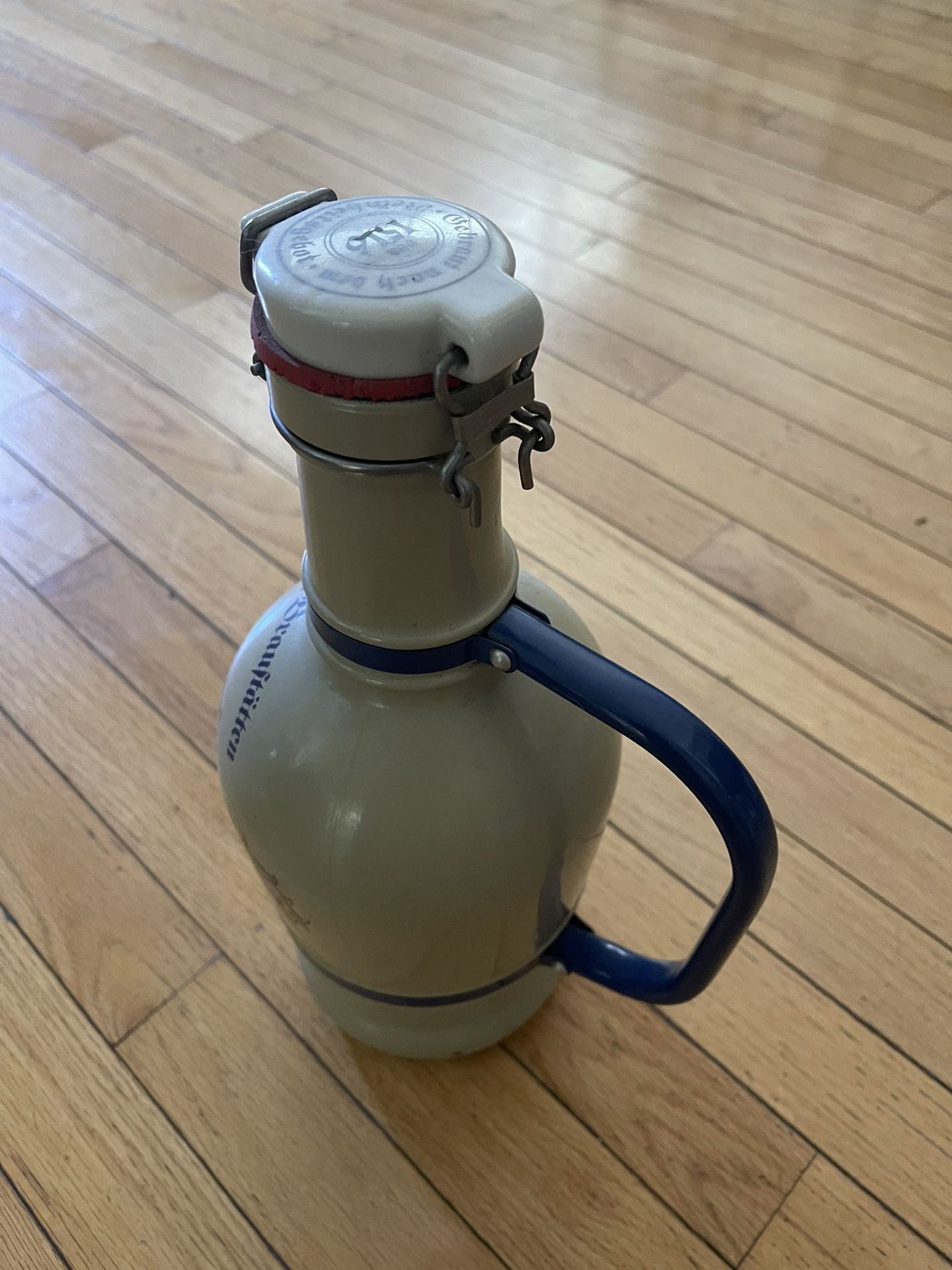 ceramic bottle with some writing on it