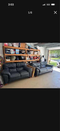 Navy blue leather couch and loveseat