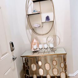 Gold console table and gold oval wall shelf 