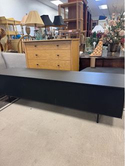 Modern Storage TV Stand features a sleek black finish - 63” x 16”
