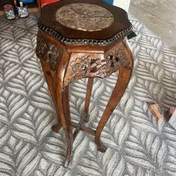 This is an antique Chinese carved rosewood and marble plant stand