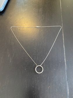 Silver necklace with charm with diamonds around