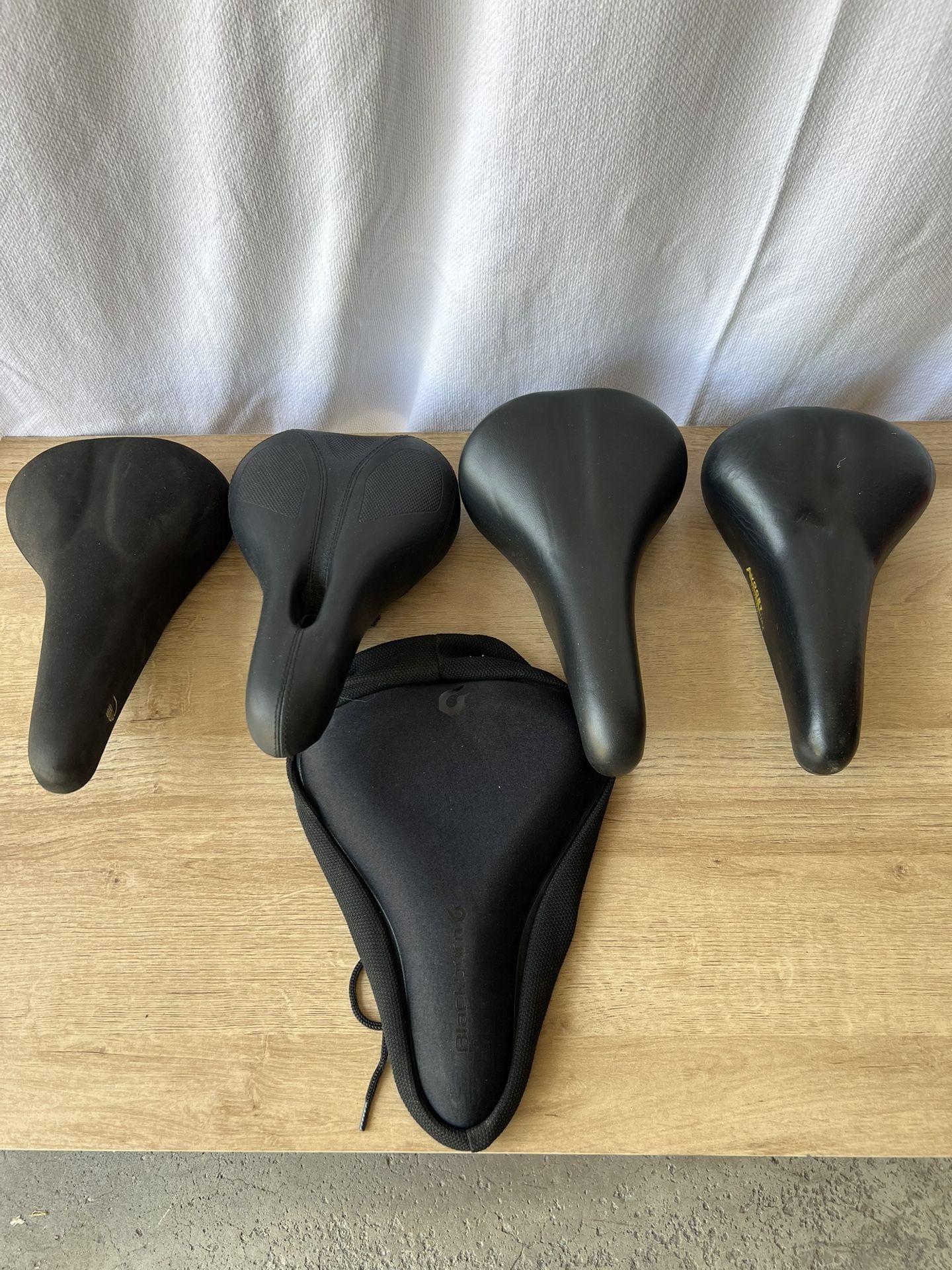 4 Bicycle Seats & 1 Seat Cover