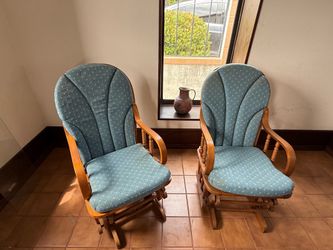 2 wood gliders with teal blue cushions.
